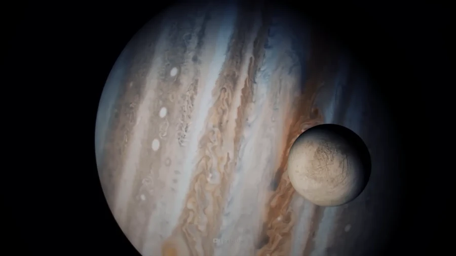 A spacecraft flying close to the planet Jupiter with one of its big moons visible, shown as an artist’s idea.